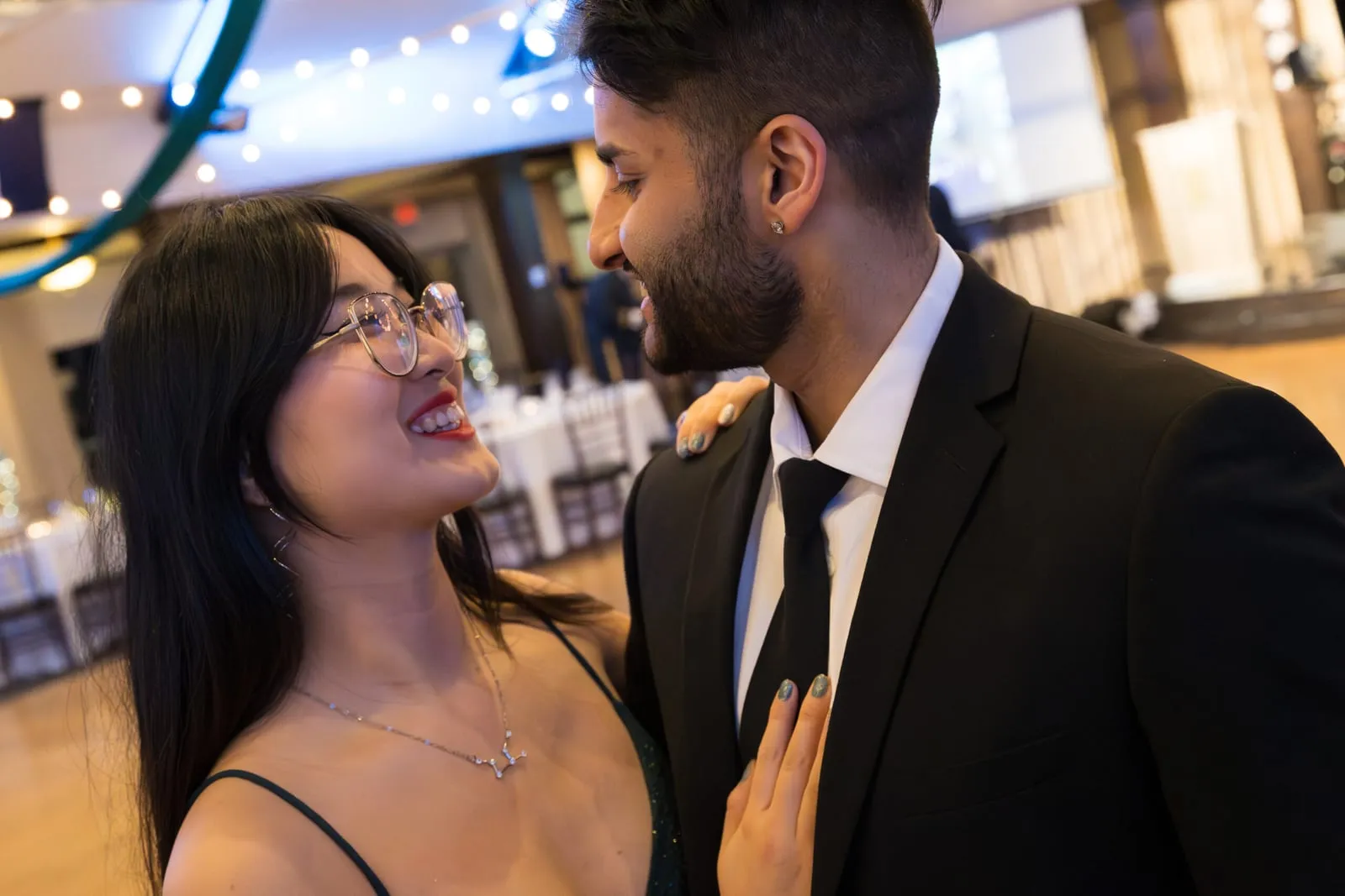 A couple laughing together at a formal ball